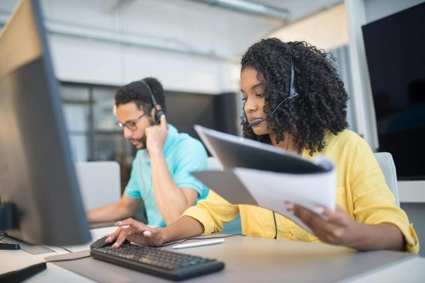 Call center agents showing IT outsourcing benefits for businesses