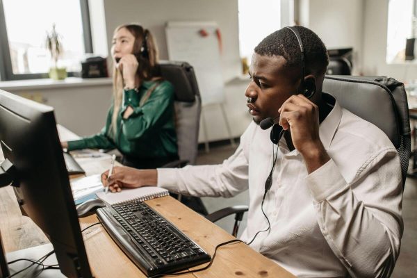 Call center team on calls highlighting offshore outsourcing benefits