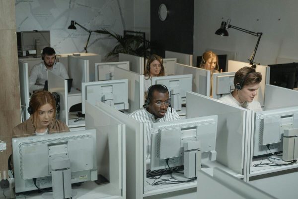 Customer service agents handling customer inquiries using one of the best SaaS help desk tools