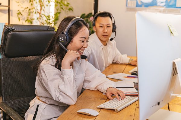 Call center agents providing customer service BPO support while with office colleague