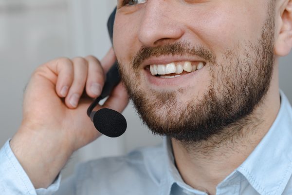 Customer support for startups specialist handling customer calls with smiling face