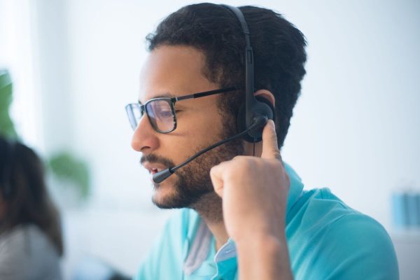 Ecommerce customer service agent wearing a headset handling customer calls and providing professional phone support.