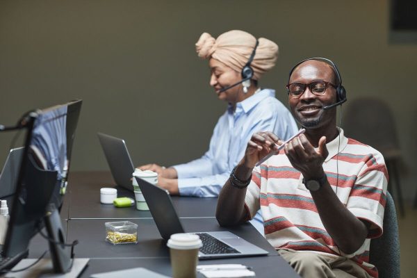 SaaS customer support agents wearing headsets handling customer calls and providing professional technical assistance.